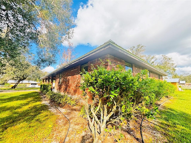 view of side of property with a yard