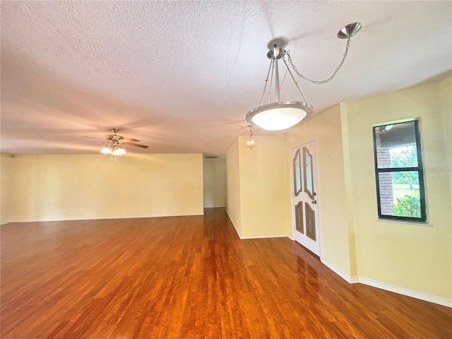 unfurnished room featuring a textured ceiling, wood-type flooring, and ceiling fan