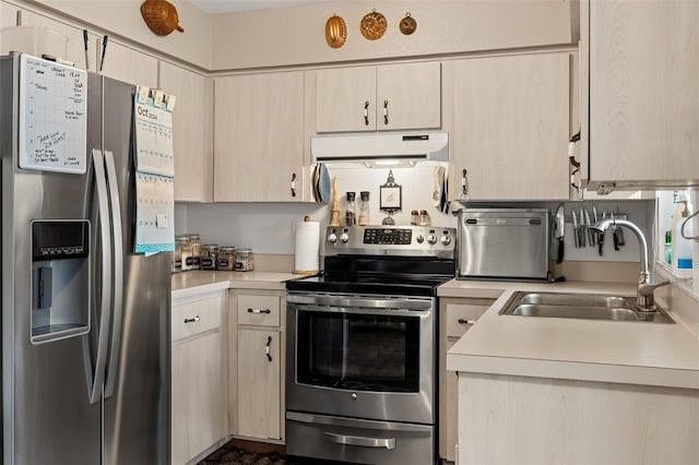 kitchen with sink, stainless steel appliances, and light brown cabinetry