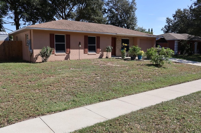 ranch-style house featuring a front yard and a garage