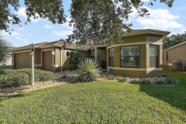 view of front facade featuring central AC, a garage, and a front lawn