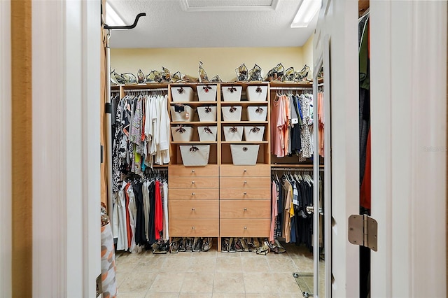 spacious closet with light tile patterned flooring