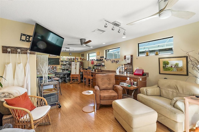 living room featuring hardwood / wood-style flooring and ceiling fan