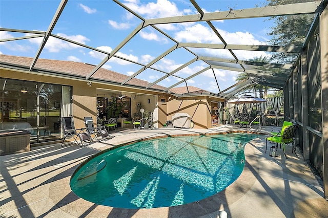 view of swimming pool featuring a patio area, a lanai, and ceiling fan