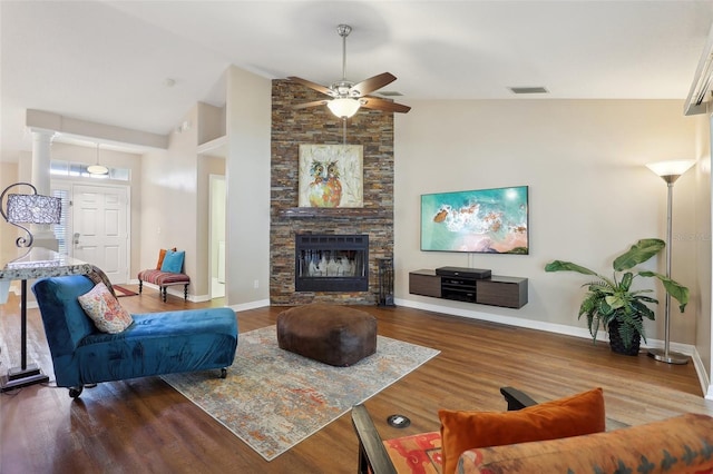 living room with ornate columns, ceiling fan, high vaulted ceiling, a fireplace, and hardwood / wood-style flooring