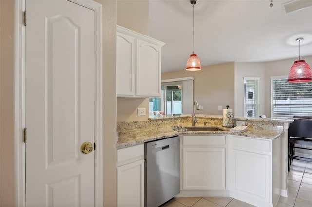 kitchen with stainless steel dishwasher, kitchen peninsula, white cabinetry, and sink