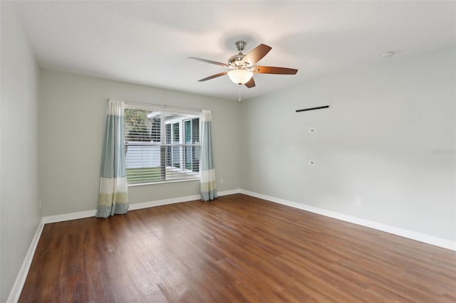 empty room with ceiling fan and dark wood-type flooring