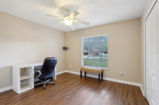 office space featuring ceiling fan, dark wood-type flooring, and a textured ceiling