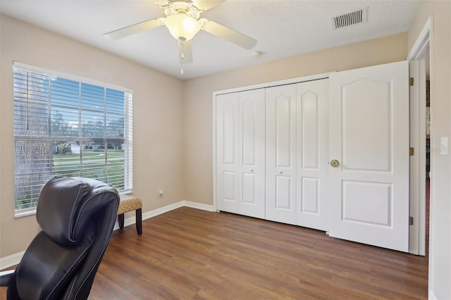 office space featuring ceiling fan, dark hardwood / wood-style flooring, and a textured ceiling