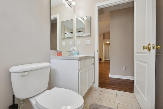 bathroom featuring vanity, wood-type flooring, and toilet