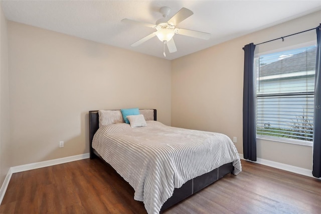 bedroom with ceiling fan and dark hardwood / wood-style flooring