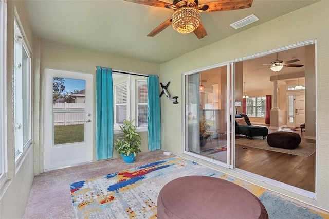 sunroom featuring ceiling fan