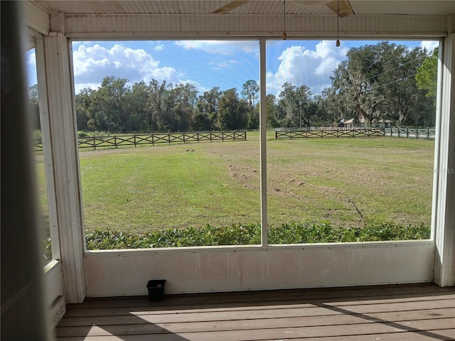 unfurnished sunroom with a rural view