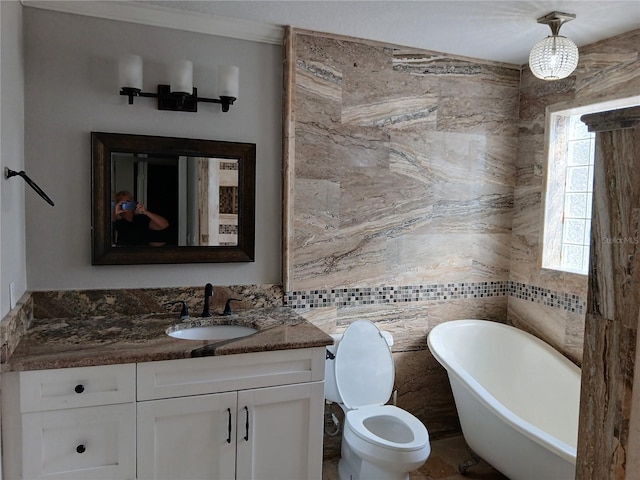 bathroom featuring tile walls, vanity, a bath, and toilet