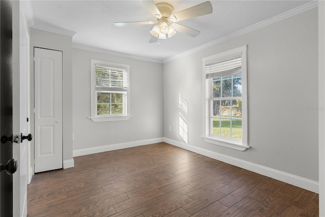 empty room featuring ceiling fan, crown molding, and dark hardwood / wood-style floors