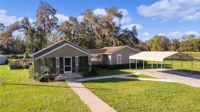 view of front of house featuring a sunroom, a carport, and a front lawn