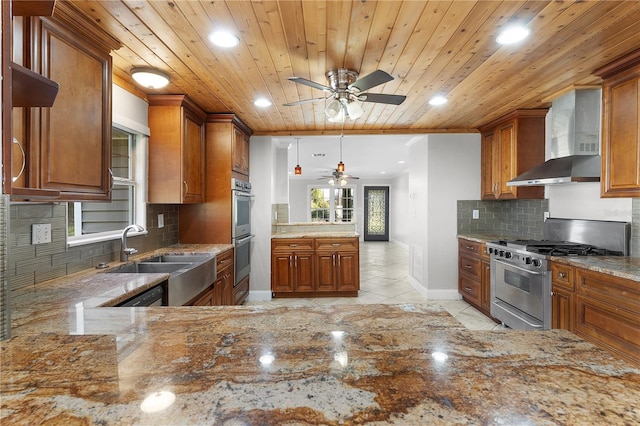 kitchen with wall chimney range hood, wood ceiling, decorative backsplash, sink, and stainless steel appliances