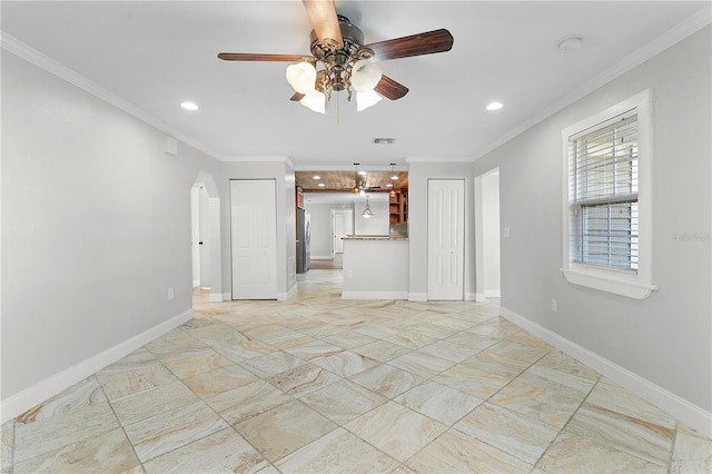 unfurnished living room featuring crown molding and ceiling fan