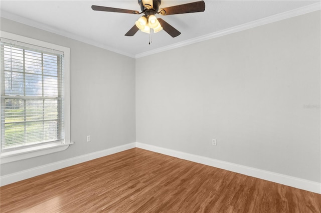 empty room with ornamental molding, hardwood / wood-style flooring, and plenty of natural light