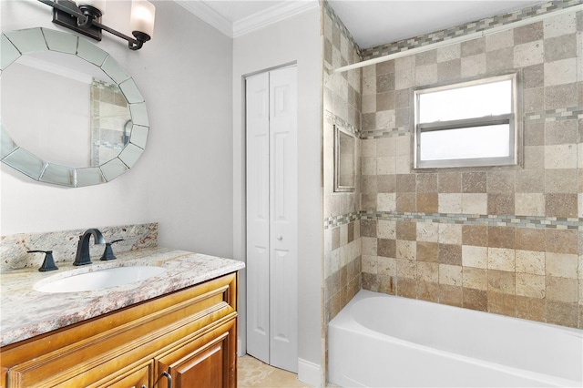 bathroom featuring tiled shower / bath, vanity, and ornamental molding