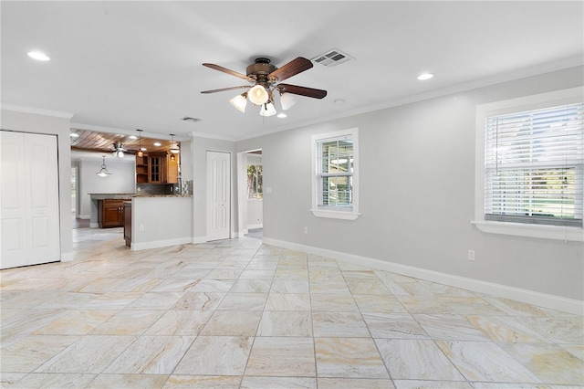 unfurnished living room with ornamental molding, a healthy amount of sunlight, and ceiling fan