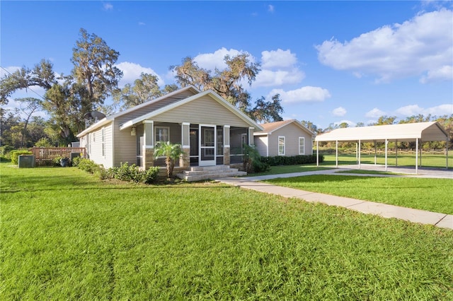 view of front of property featuring a front yard and a sunroom