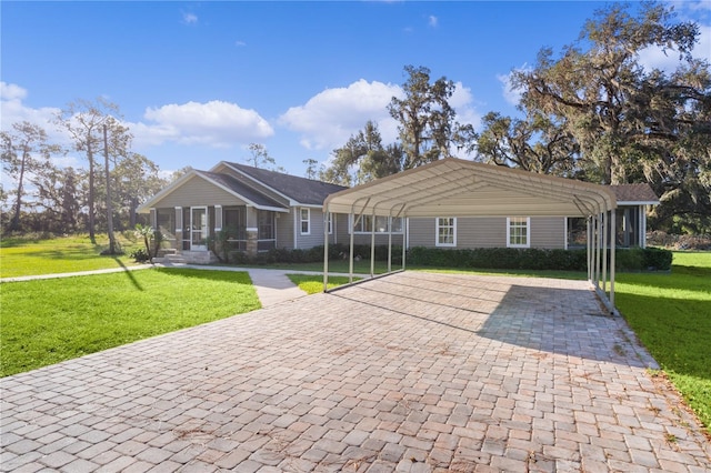 ranch-style house featuring a sunroom, a front yard, and a carport