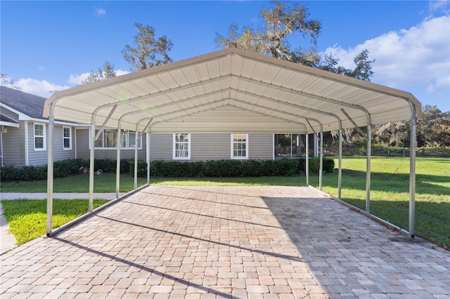 view of vehicle parking featuring a lawn and a carport