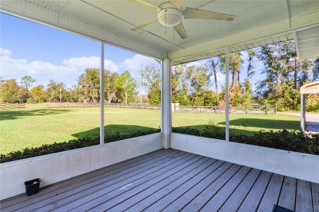 unfurnished sunroom with a healthy amount of sunlight and ceiling fan