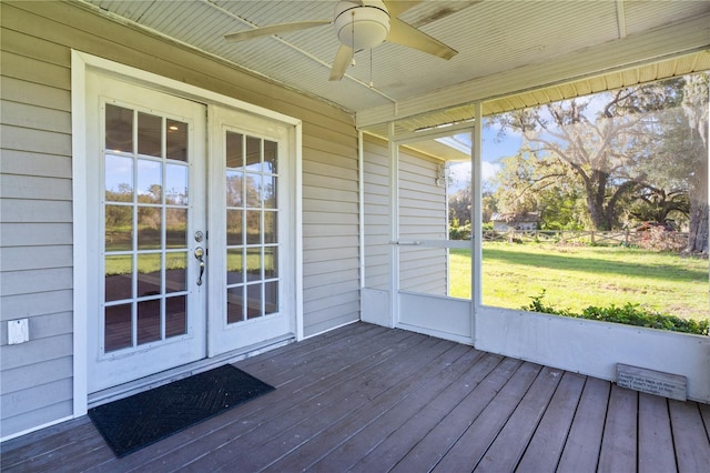 unfurnished sunroom featuring ceiling fan