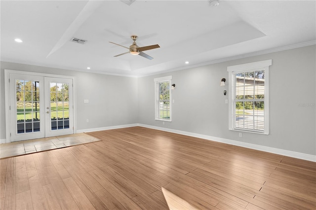 spare room featuring french doors, a wealth of natural light, and light wood-type flooring