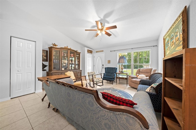 tiled living room with a textured ceiling and ceiling fan