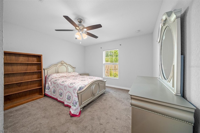 bedroom with ceiling fan and light colored carpet