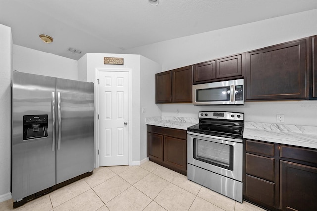 kitchen featuring stainless steel appliances, dark brown cabinets, and light tile patterned floors