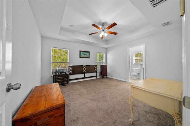 interior space featuring a textured ceiling, a tray ceiling, and ceiling fan