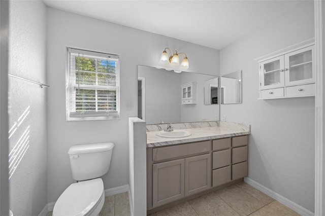 bathroom featuring vanity, toilet, and tile patterned floors