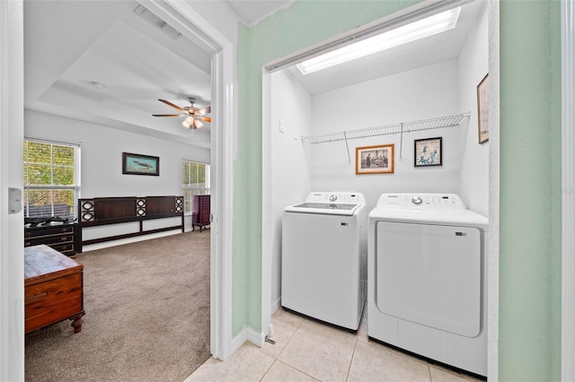 washroom featuring washer and dryer, light carpet, and ceiling fan