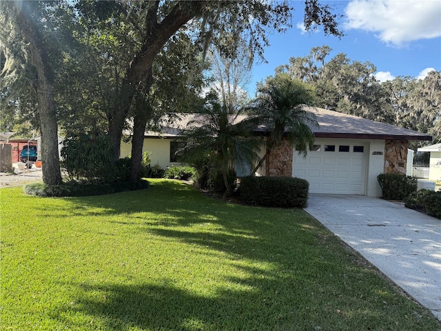 single story home featuring a front lawn and a garage