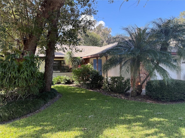 view of side of home featuring a lawn