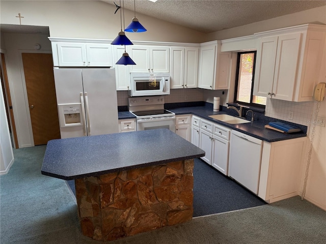 kitchen featuring decorative backsplash, sink, vaulted ceiling, pendant lighting, and white appliances