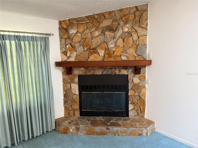 interior details featuring a textured ceiling, carpet floors, and a fireplace