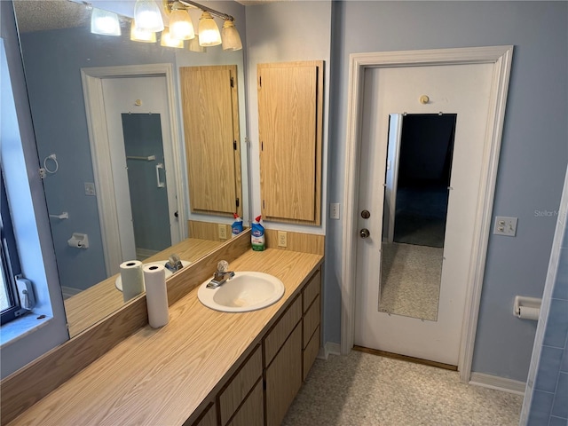 bathroom with vanity and a textured ceiling