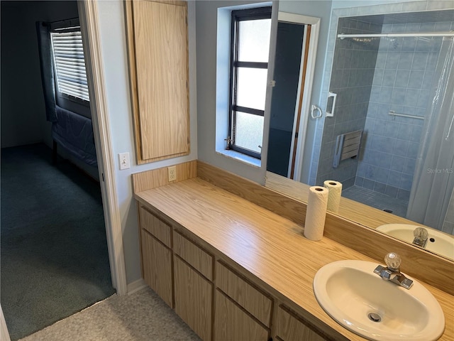 bathroom with vanity and tiled shower