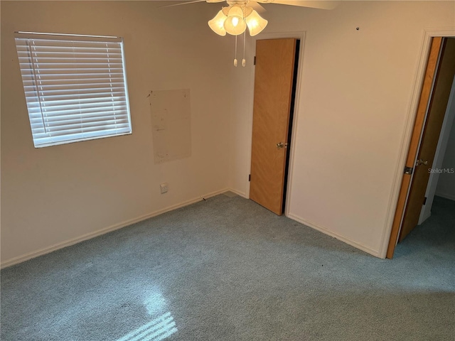 interior space with light colored carpet and ceiling fan