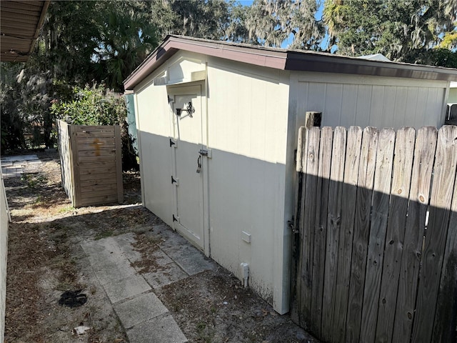 view of side of home with a storage shed