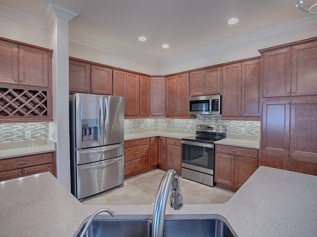 kitchen featuring appliances with stainless steel finishes, sink, backsplash, crown molding, and light tile patterned floors