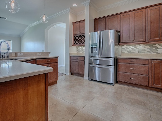 kitchen with lofted ceiling, decorative backsplash, hanging light fixtures, stainless steel fridge with ice dispenser, and crown molding