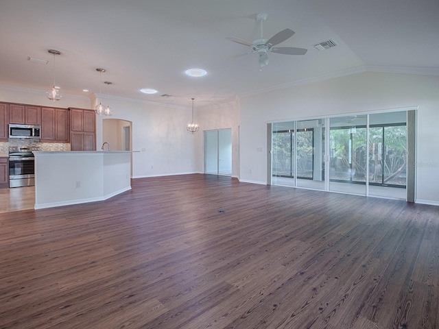 unfurnished living room featuring crown molding, ceiling fan with notable chandelier, vaulted ceiling, and dark hardwood / wood-style flooring