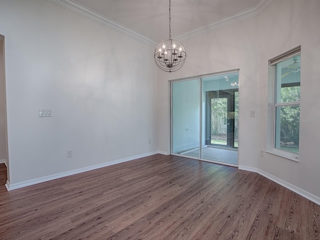 unfurnished room with ornamental molding, a chandelier, hardwood / wood-style floors, and a wealth of natural light