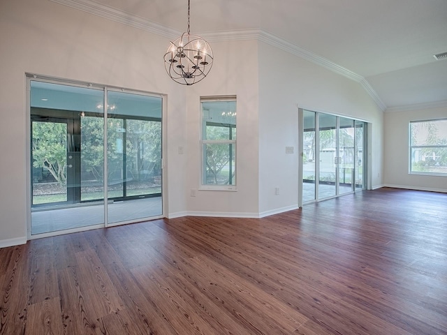 interior space with dark wood-type flooring, vaulted ceiling, crown molding, and a chandelier